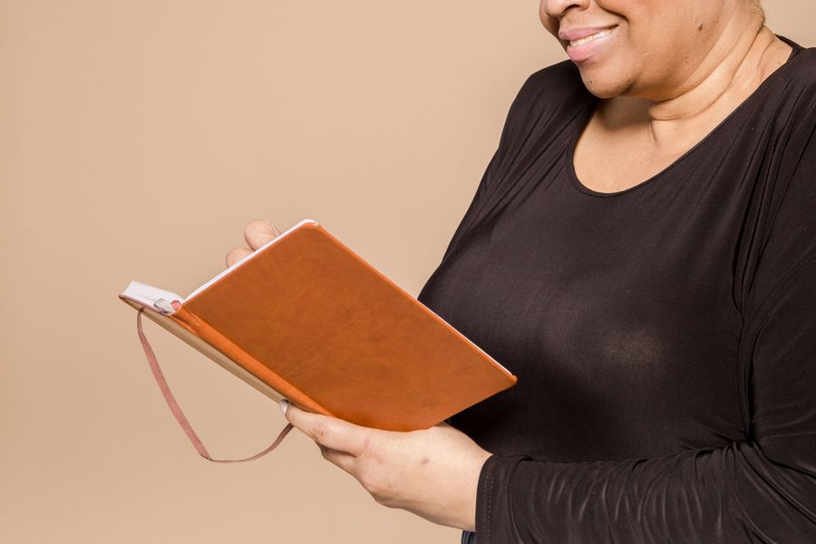 A woman reflecting with her journal